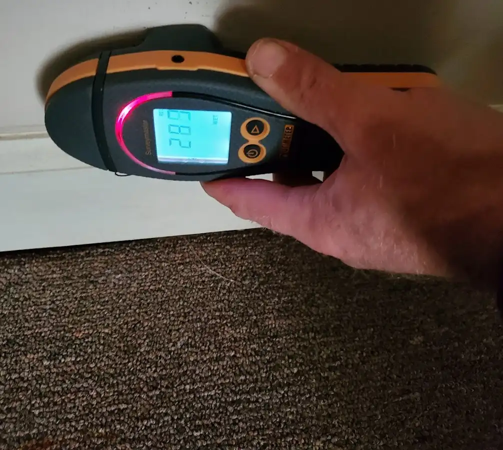 Moisture detection at baseboard during Storm Damage Restoration in Freeport